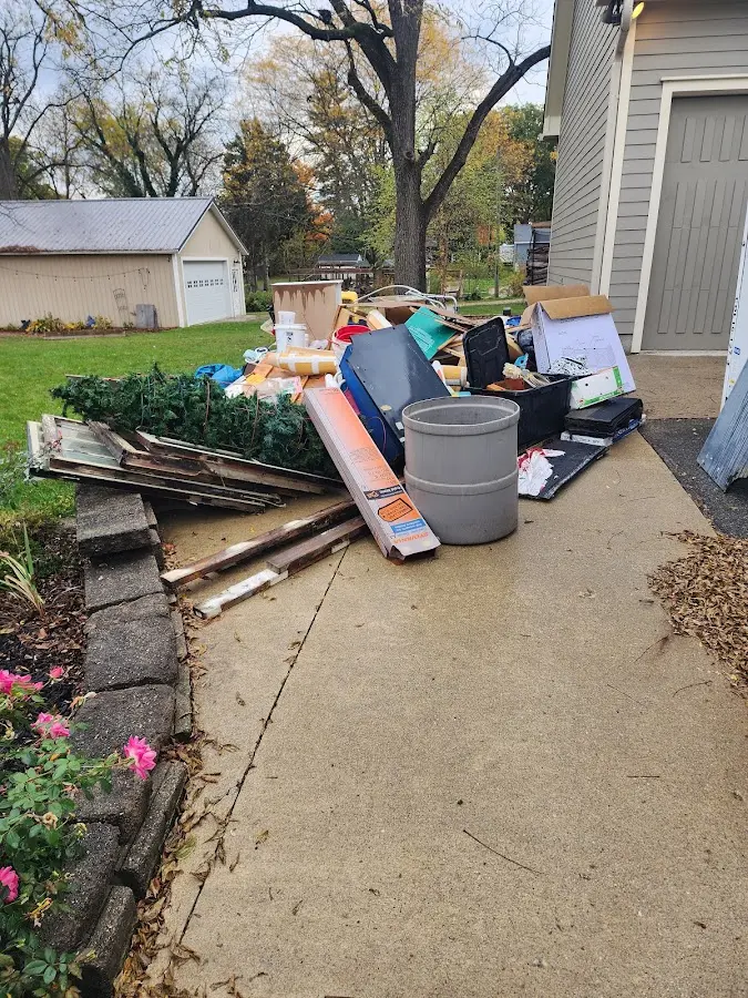 Dumpster being loaded with debris for Estate Cleanout Dumpster Rental in Clear Lake